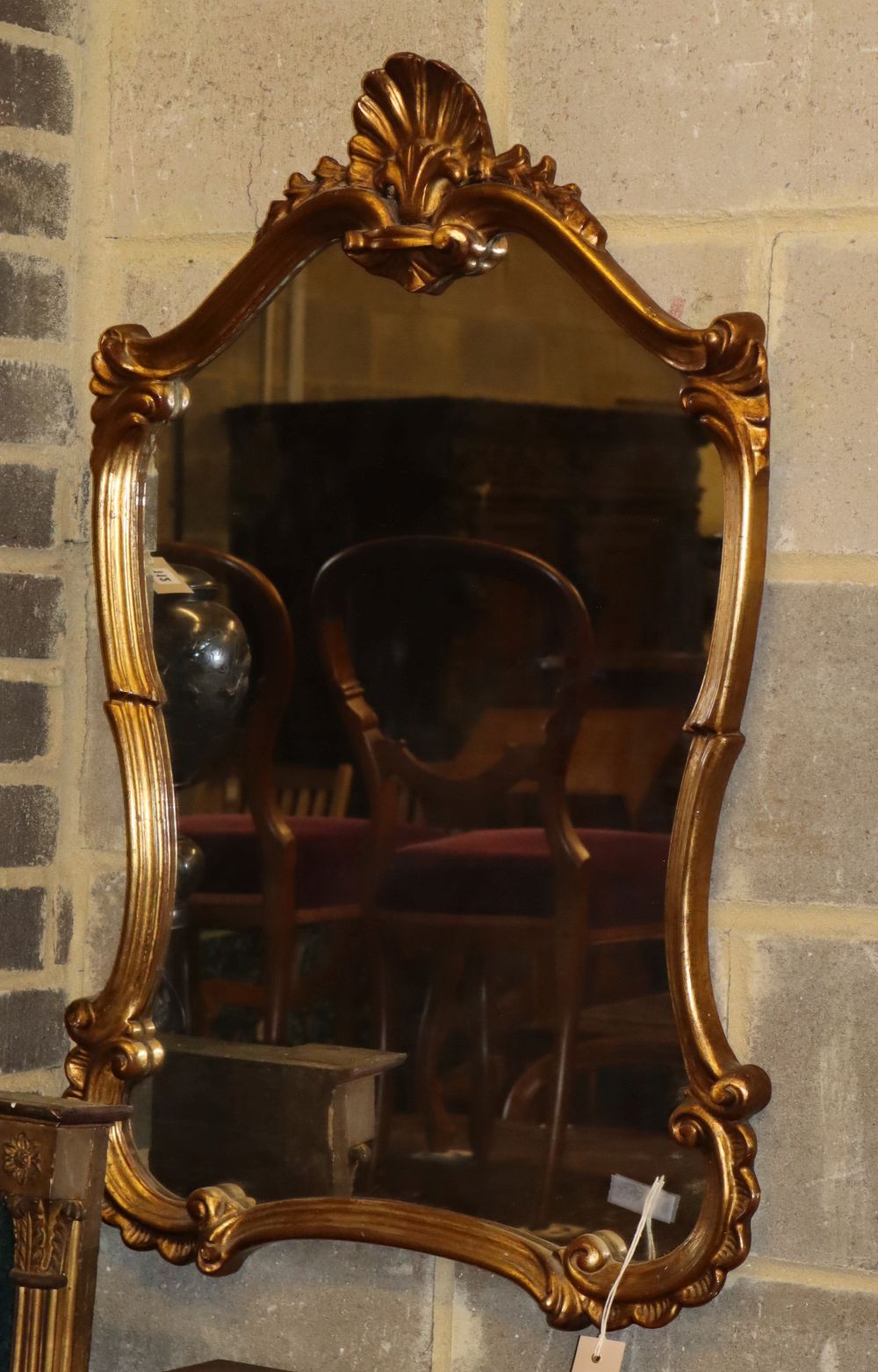 An 18th century style gilt framed cartouche shaped wall mirror, 58 x 86cm